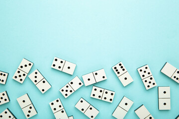 Domino pieces on the blue background with copy space