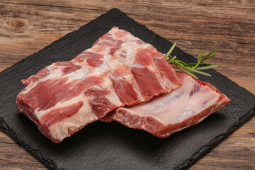 Raw pork ribs served rosemary
