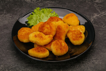 Fried chicken nuggets served salad leaves