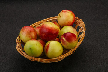 Sweet small nectarines in the basket