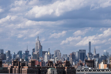 New York City skyline with clouds taken from Brooklyn bridge. Place fot text on sky