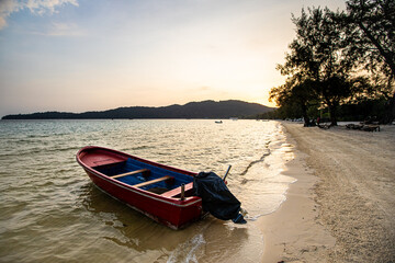 Moored fishing boats at sunset on the sands of a quiet island