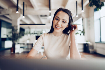 Close up portrait of a young woman working in office at the table