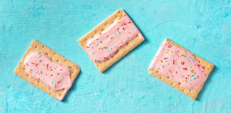 Pop tarts flat lay panorama on a blue background. Strawberry toaster pastry