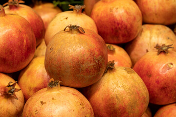 Fototapeta na wymiar Organic pomegranate. Close-up pomegranate background