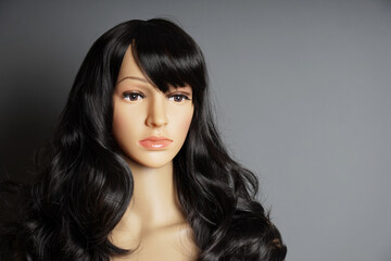shop window mannequin or display dummy head with brunette wig and naturalistic face