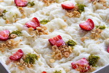 Close-up walnut gullac dessert. Traditional Ramadan dessert. Middle Eastern desserts. Local name güllaç dessert