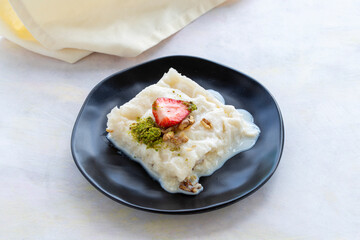 Gullac on a white background. Traditional Ramadan dessert. Milk dessert. Local name Güllaç