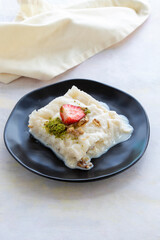 Gullac on a white background. Traditional Ramadan dessert. Milk dessert. Local name Güllaç