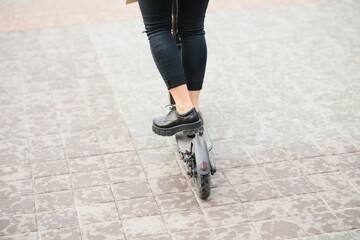 Portrait of a young woman with electro scooter