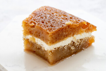 Creamy bread dessert on a white background. Local name kaymaklı ekmek kadayıfı