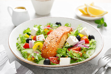 Salmon fish salad. Fresh vegetable greek salad with tomato, pepper, lettuce, olives, cucumbers,...
