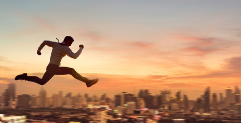 Young businessman jumping high, Work, job, or successful business concept. Cityscape background.