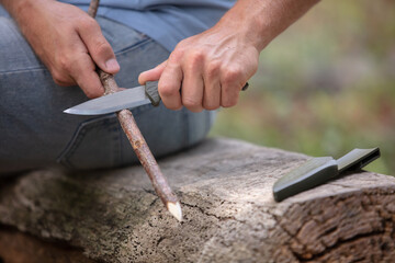 closeup of a man preparing a wood sculpture