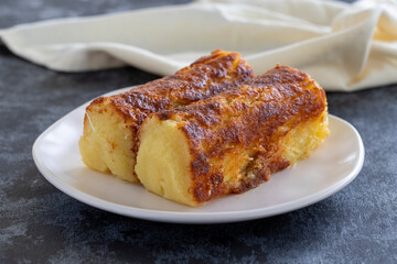 Cheese dessert on a dark background. Traditional Middle Eastern cuisine flavors. Cheese halva. Local name peynir helvası yada peynir tatlısı