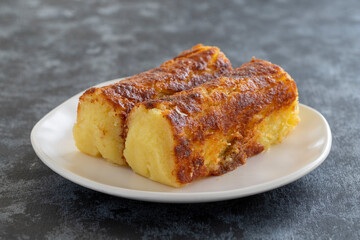 Cheese dessert on a dark background. Traditional Middle Eastern cuisine flavors. Cheese halva. Local name peynir helvası yada peynir tatlısı