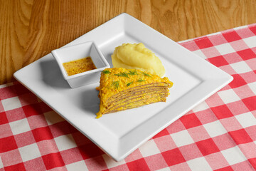 Liver Cake. One piece of meat liver cake amde of pancakes with mashed potatoes and french mustard