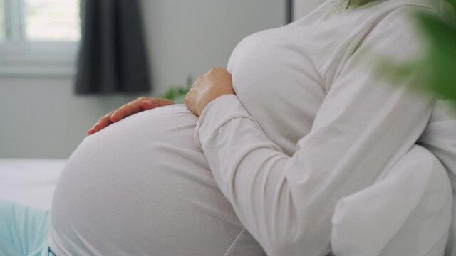 Pregnant women use hand touch on stomach during 7 months of pregnancy. Patting the belly while pregnant is a common gesture of gestures to capture the reactions of the unborn child.