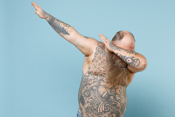 Young fat pudge obese chubby overweight blue-eyed bearded man 30s has big belly with naked tattooed...
