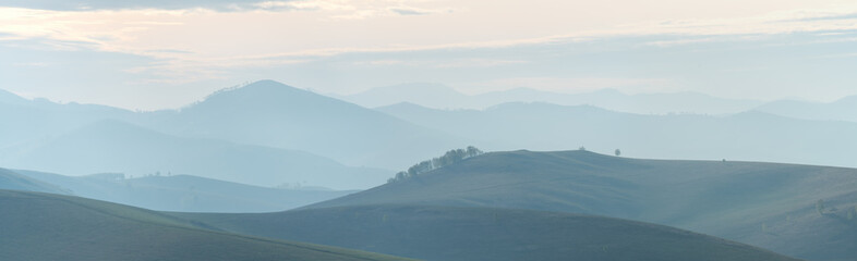 Mountains and hills in the morning haze, panoramic view