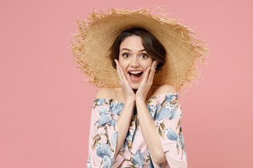 Young excited amazed surprised caucasian woman 20s with short hairdo in trendy blouse straw hat look camera hold face isolated on pastel pink color background studio portrait People lifestyle concept.