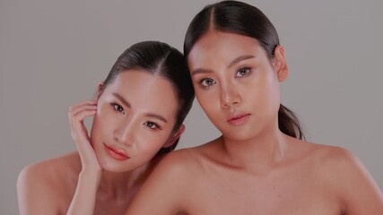 Beautiful face of Two Asian young women with natural skin. Couple of beautiful girls with white skin and tanned skin.