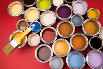 Paintbrush on cans with color