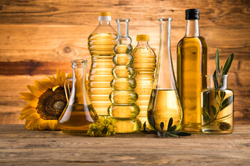 Obraz na płótnie Canvas Cooking oils, Olive oil, Rape, Sunflower flowers in bottles