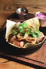 Grilled shashlik served on lavash bread in a frying pan. Shashlik or Shish kebab.