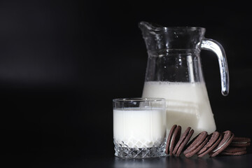 Milk drink in a glass. Farm milk and cookies. Delicious snack with cow's milk and fresh pastries.