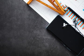 Mobile phone and earphones on the table. Listen to music on the go. Online player. Audio applications for smartphones.