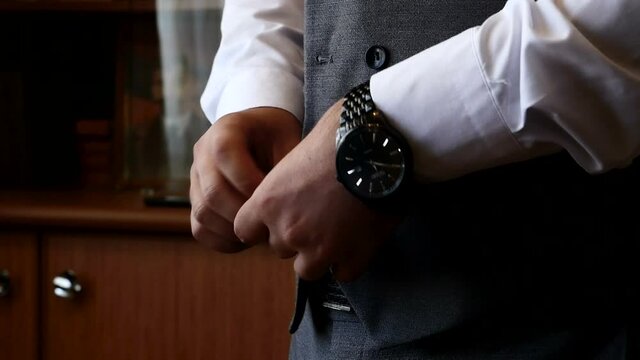 Stylish man in a fashion jacket preparing to go out at a reception or wedding. 