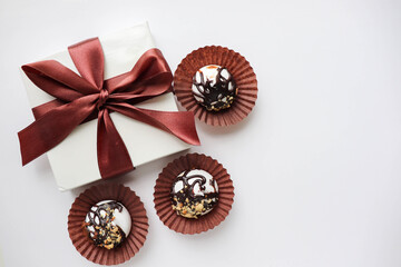 gift box on a white background and chocolate candies. space for text