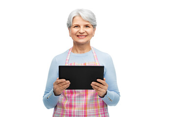 cooking, culinary and old people concept - portrait of smiling senior woman r in kitchen apron with tablet pc compute over white background