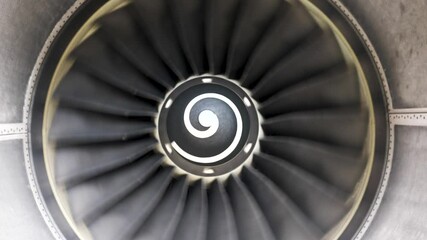 The rotation of airplane engine. Front view of aircraft engine turning. Jet engine rotation.4K - Powered by Adobe