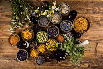 Homeopathy, herbal medicine on wooden table