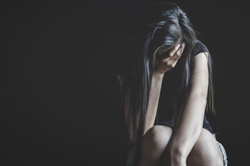 depressed woman sitting in the corner of the room and feeling fear violence from harassment,  domestic and rape violence, beaten and raped sitting in the corner,  Copy space.
