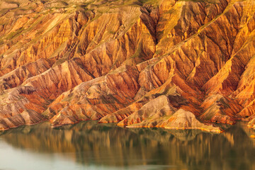 Landscape with arid eroded badlands along the Yellow river in Kanbula national forest park, Qinghai...