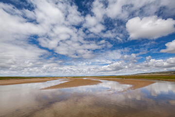 Obraz premium Landscape with river and sky with white clouds reflecting in the water on the Tibetan plateau, Qinghai province, China