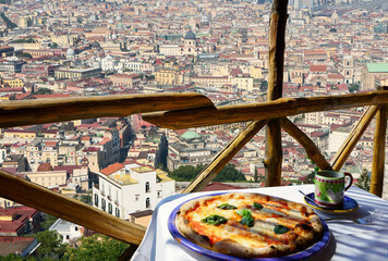       Italian pizza Margarita served on terrace with Naples view, Italy