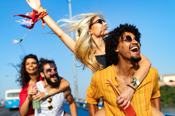 Group of young happy friends enjoying outdoor music festival