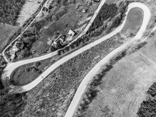 Fototapeta premium Asphalt road serpentine. Aerial view from drone. Black and white image.