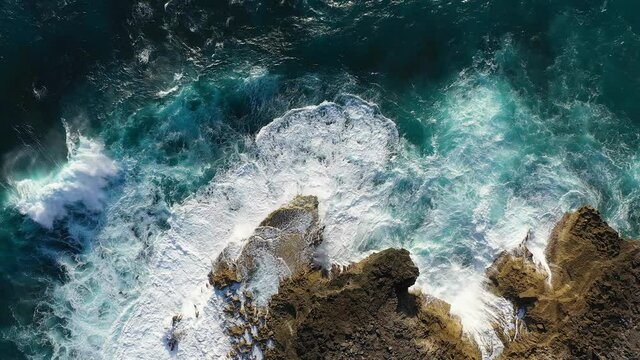 Huge wave splashing against the rocky coastline of Nusa lembongan, an area called the devil tears with its powerful waves, in Bali, Indonesia
