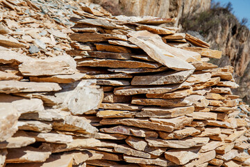 Natural flat stone is collected from the side of the mountain and used for construction and...