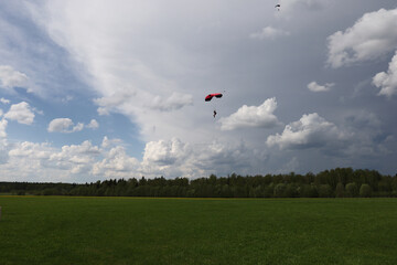 Skydiving. A parachute. Amazing clouds.