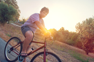 Naklejka premium Boy in a bicycle outdoors