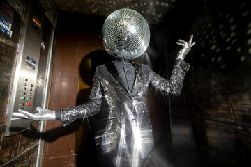 Mr disco ball dancing in a lift