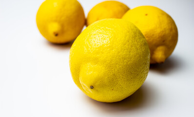 Gorgeous fragrant lemon fruits on a white table