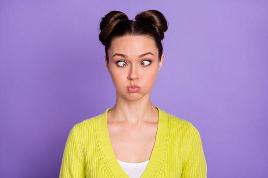 Photo portrait of silly fooling girl grimacing keeping air in cheeks isolated on pastel purple color background