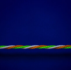 A rope made with Indian tricolors- orange, green and white strings. A metaphor for unity and communal harmony in India.